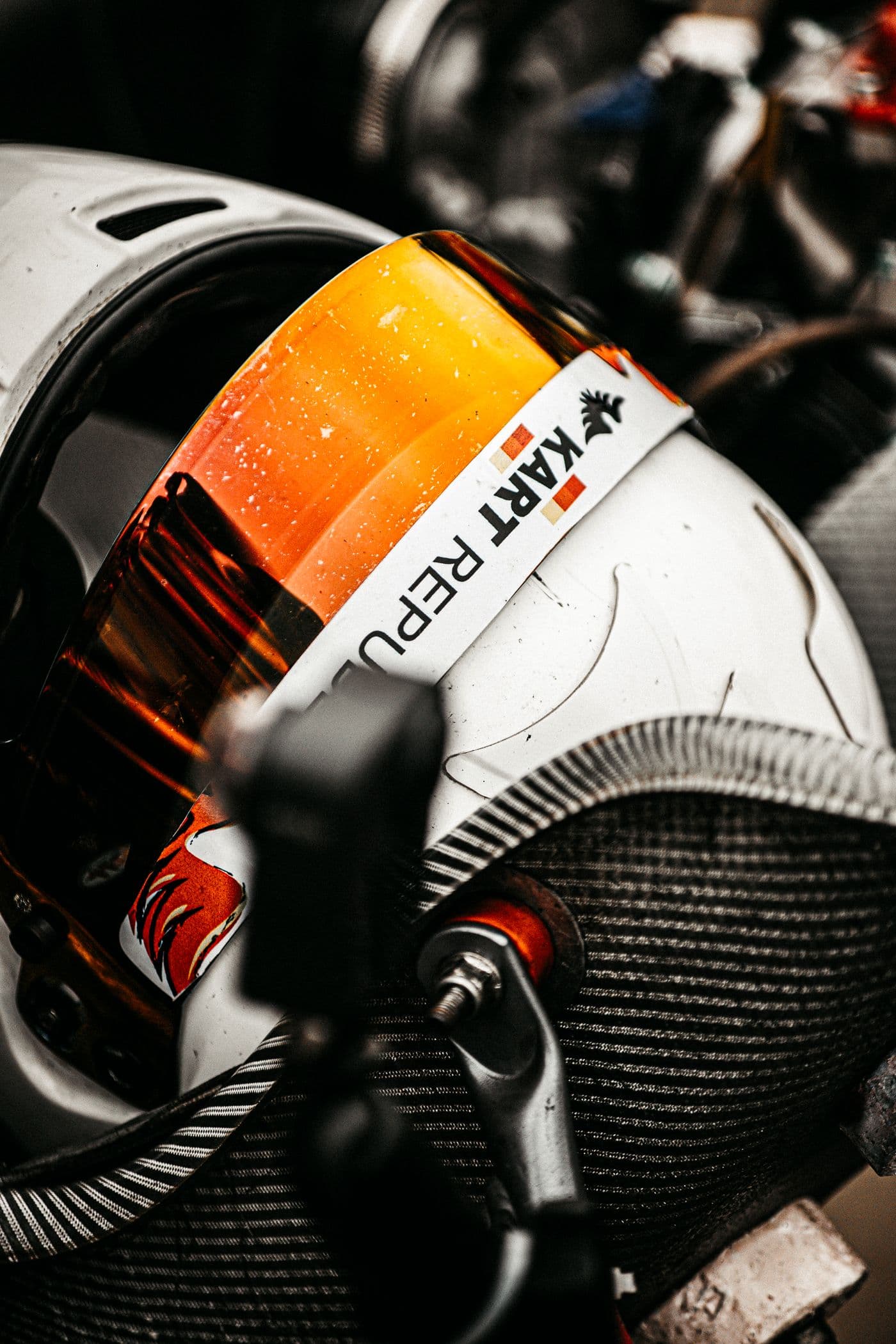 Close-up of a racing helmet and kart