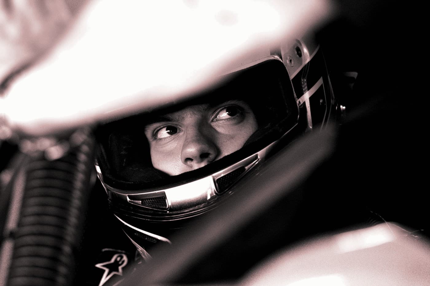 A young driver focused inside the helmet