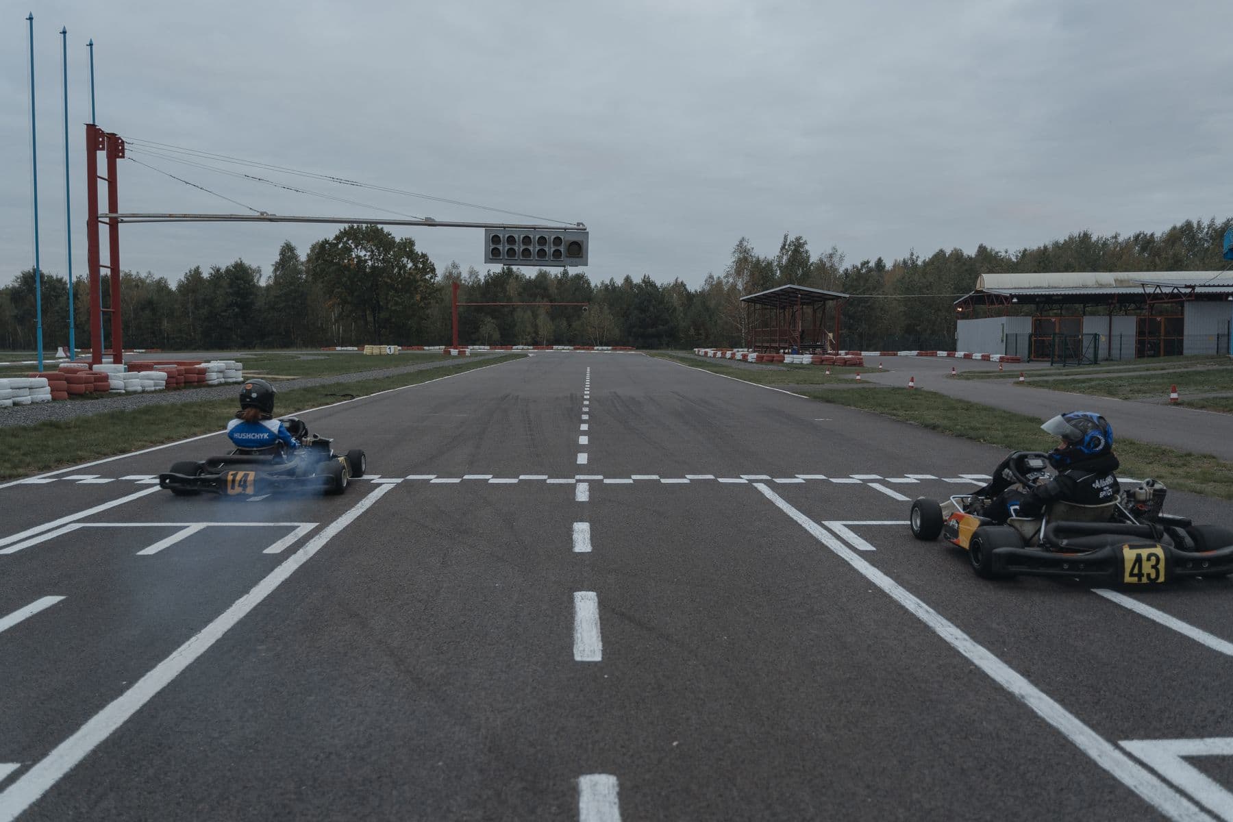 An empty kart track straightaway with a start line